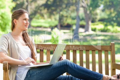 Woman with her notebook on a park bench