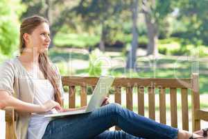 Woman with her notebook on a park bench