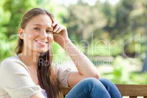 Smiling woman on a bench in the park