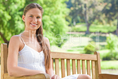 Smiling woman on a park bench