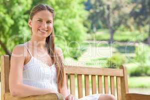 Smiling woman on a park bench