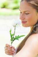 Close up of a woman smelling a flower