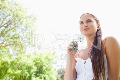 Woman with flower enjoying the day in the park