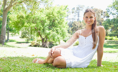 Smiling woman relaxing on the lawn