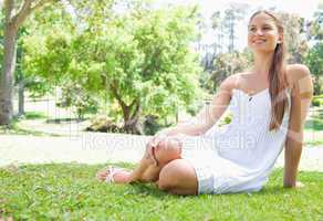 Smiling woman relaxing on the grass