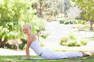 Side view of a woman doing her stretches in the park