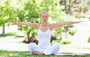 Woman in the park doing her yoga exercises
