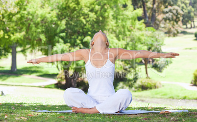 Woman on the lawn doing yoga exercises