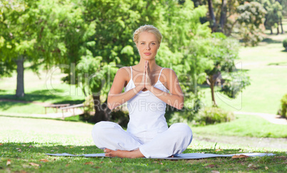 Woman on the grass doing yoga exercises