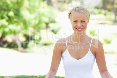 Relaxed smiling woman sitting on the lawn