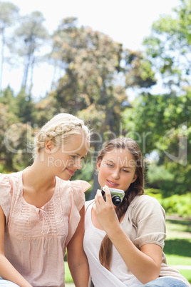 Friends looking at recent photos on their camera
