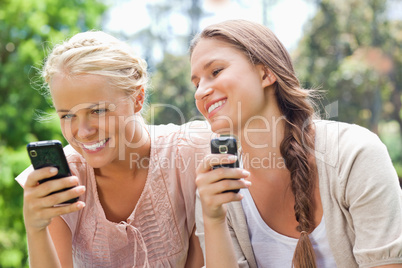 Smiling friend with cellphones