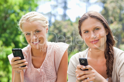 Friends with their cellphones in the park