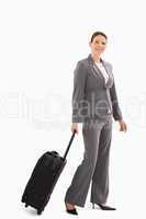 Businesswoman with suitcase walking