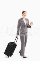 Businesswoman with coffee and suitcase
