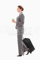 Businesswoman with suitcase holding coffee