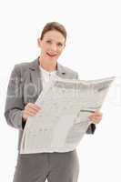 Surprised businesswoman holding newspaper