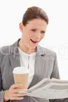 surprised businesswoman reading newspaper