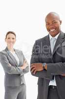 Smiling businessman and woman with folded hands