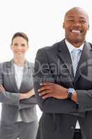 Laughing businessman stands infront of businesswoman