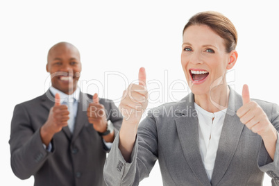 Excited businesspeople with thumbs up
