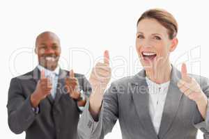 Excited businesspeople with thumbs up