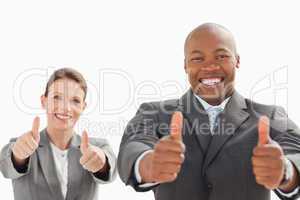 Businessman and woman with their thumbs up