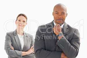 Businessman and woman posing