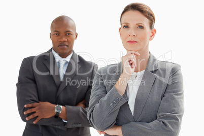 Businesswoman resting head on hand in front of businessman