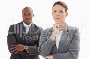 Businesswoman resting head on hand in front of businessman