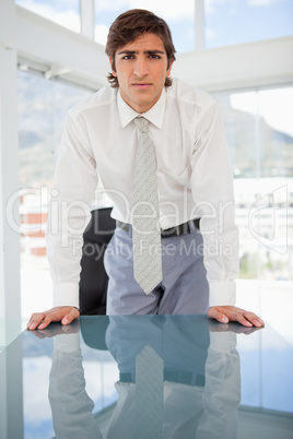 young serious businessman staring at the camera
