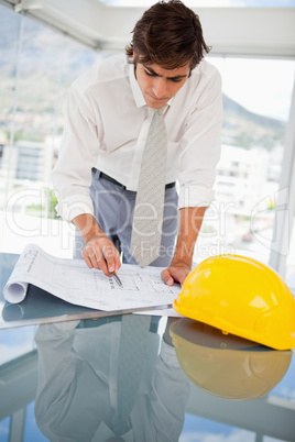 Businessman looking at construction drawings