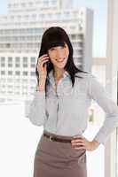 A smiling business woman taking a call