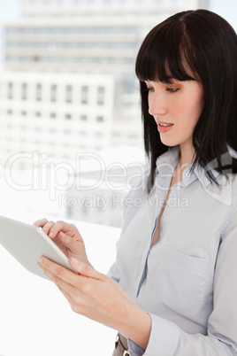 A woman using her tablet pc in her office