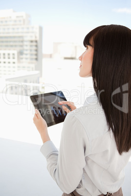 Woman looking up as she uses her tablet pc