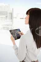 Woman looking up as she uses her tablet pc