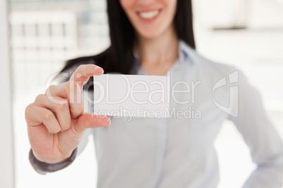 Close up of a business card being held by a woman
