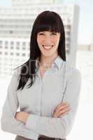 A smiling business woman with her arms folded
