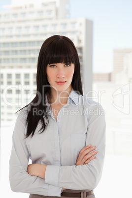 A woman in her office with her arms crossed