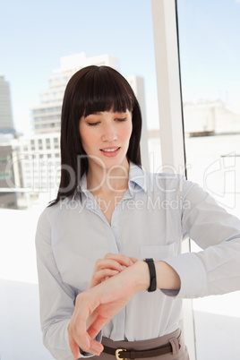 A business woman checks the time with her watch