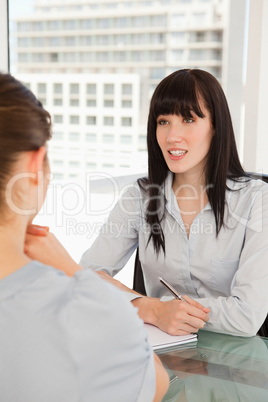 The smiling business woman chats to the other woman