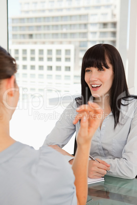 Both women enjoy a joke with one another