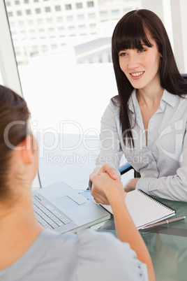 Both women shake hands after a good interview