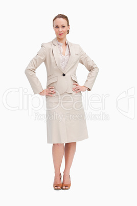 Portrait of a woman in a suit with her hands on her hips