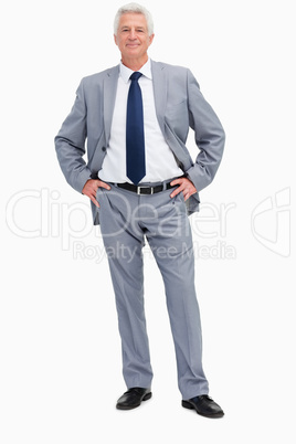 Portrait of a man in a suit with hands on hips