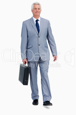 Portrait of a businessman with a suitcase walking