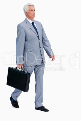 Businessman with a suitcase walking