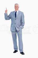 Portrait of a happy businessman pointing up