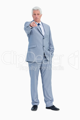 Portrait of a businessman pointing to someone