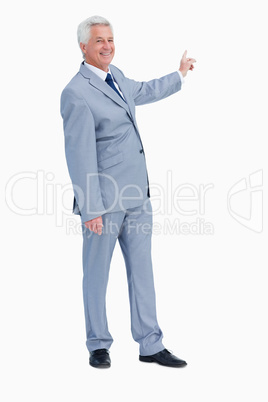 Portrait of a businessman pointing behind him
